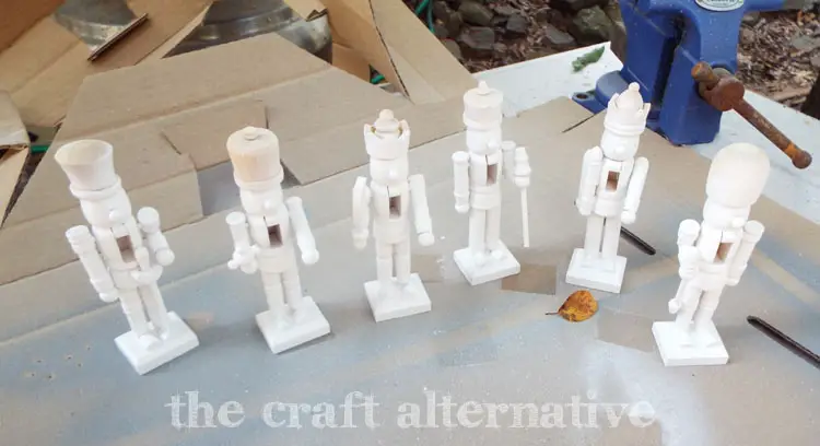 DIY Painted Nutcrackers with Glitter Hats spray painted with white