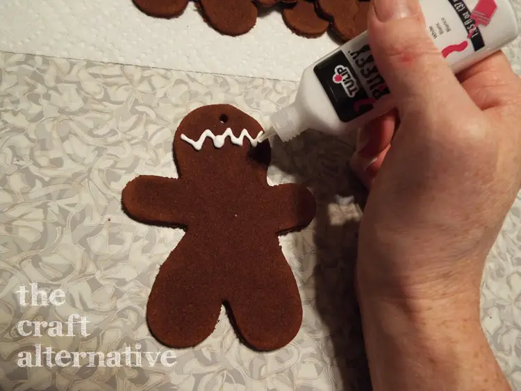 How to Make Cinnamon-Applesauce Dough Holiday Ornaments decorating gingerbread man with paint