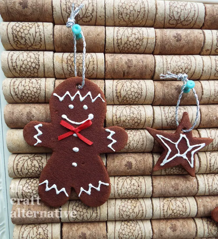 How to Make Cinnamon-Applesauce Dough Holiday Ornaments gingerbread ornament displayed on cork board
